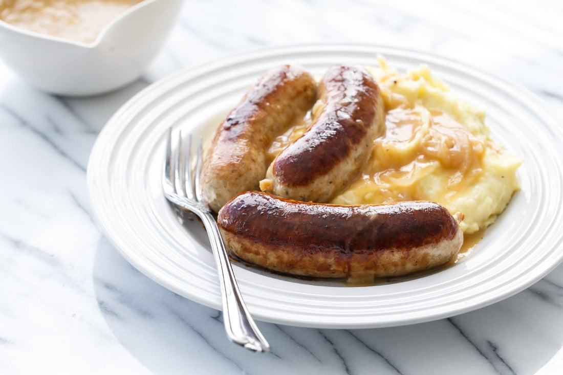 A plate of banegrs and mash, a traditional british dish with British Sausages, Mash Potatoes and Gravy