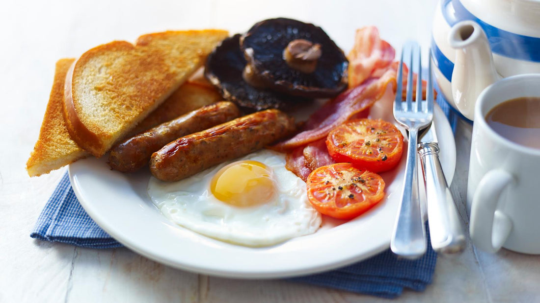 A proper full english breakfast with; eggs, bacon, mushrooms, black pudding, tomatoes, sausages and toast