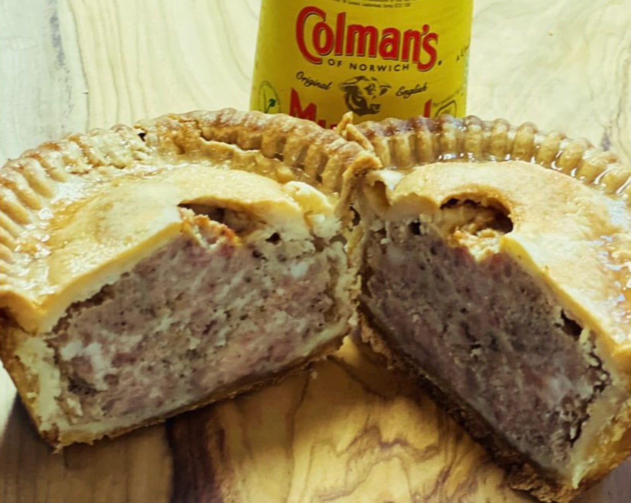 These traditional pork pies are made with ground pork seasoned with special seasoning in a rich pork jelly and set in a water crust pastry, cut in half